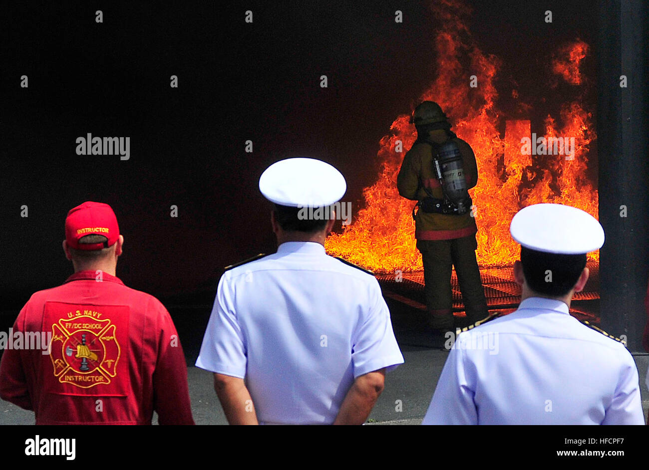 Vice Adm. Pongthep Nhuthep, assistant chief of staff for operations of the Royal Thai Navy and his staff observe firefighting training during an official visit and guided tour of the Surface Warfare Officers School, Engineering Learning Site Pearl Harbor. U.S. and Royal Thai militaries have been treaty allies for more than 180 years and security allies since the end of World War II. (U.S. Navy photo by Mass Communication Specialist 2nd Class Tiarra Fulgham/Released) Pearl Harbor tour 140401-N-QG393-047 Stock Photo