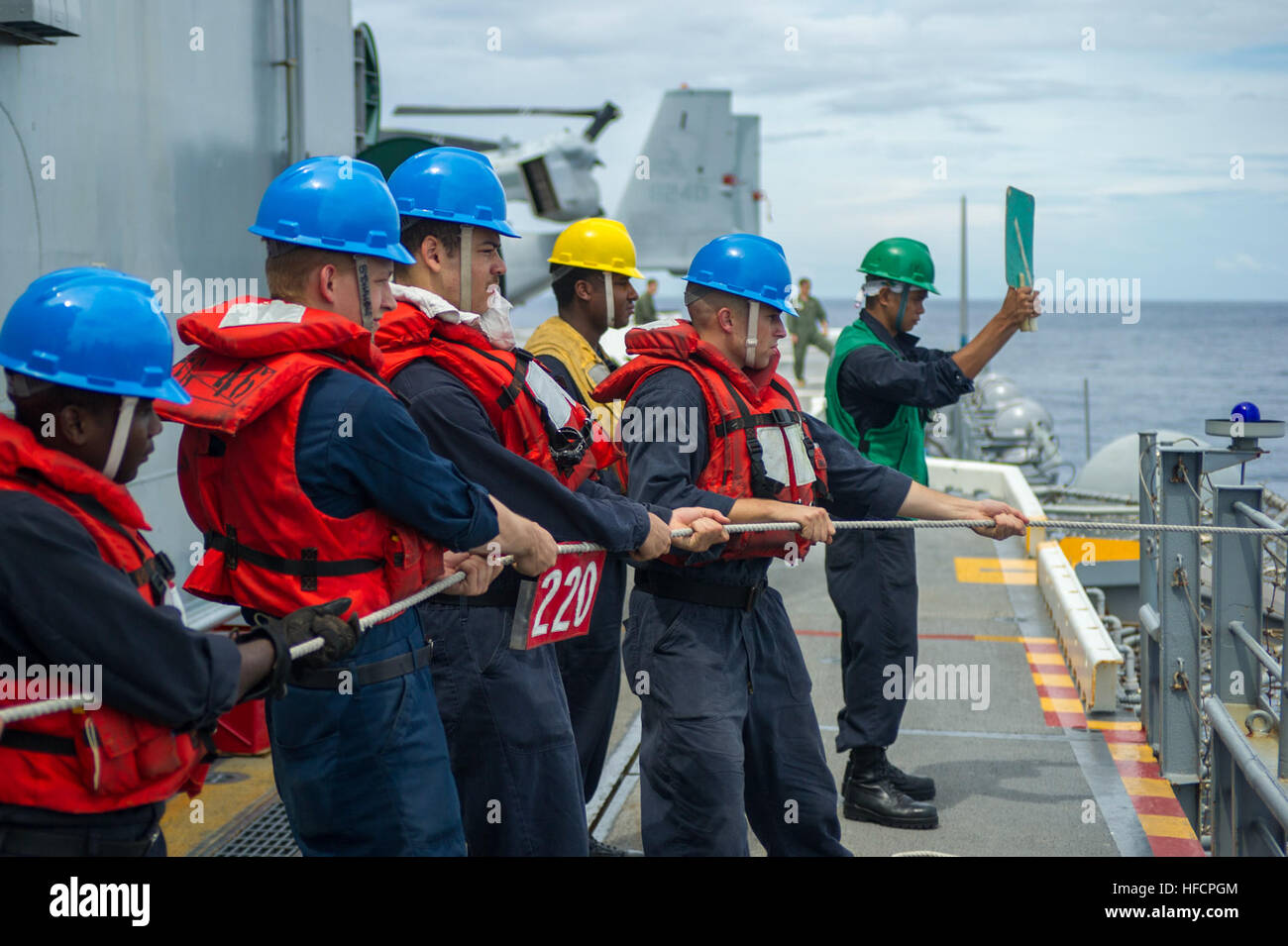 Sailors aboard the amphibious assault ship USS Peleliu (LHA 5) maintain ...
