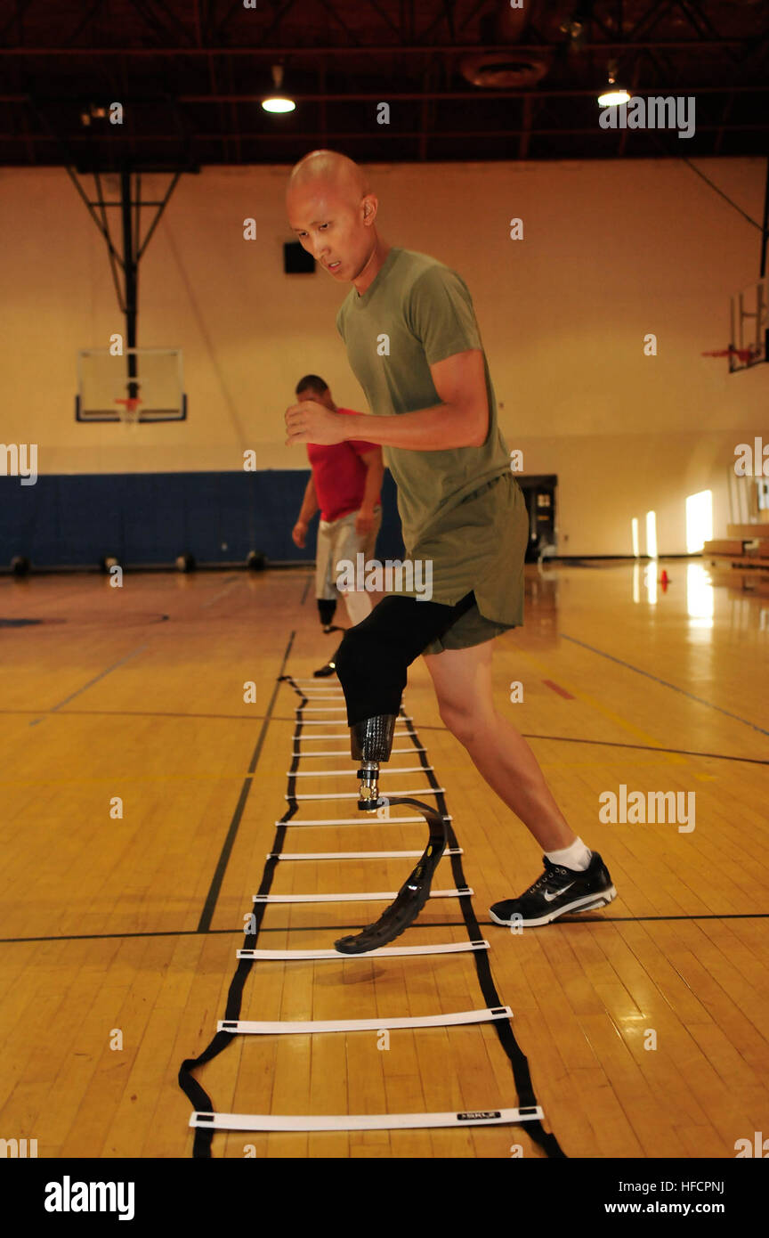 Marine Sgt. Lam Le, assigned to the Wounded Warrior Battalion-West detachment at Naval Medical Center San Diego, performs step exercises during a demonstration of the agility clinic as part of the Comprehensive Combat and Complex Casualty Care (C5) program at NMCSD. The demonstration is part of a weeklong schedule of events commemorating C5's five years of rehabilitating service members. America's sailors are Warfighters, a fast and flexible force deployed worldwide. Join the conversation on social media using #warfighting. (U.S. Navy photo by Mass Communication Specialist 2nd Class Sean P. Le Stock Photo