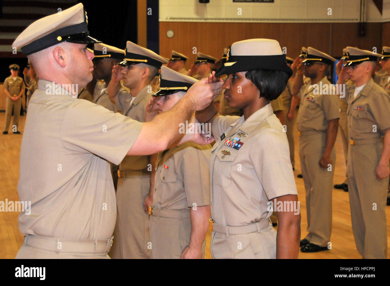 Senior Chief Mineman Chris Bender, a recruit division commander at Officer Candidate School, corrects the salute of candidate officer Kristen Hodge, from Clinton, Md., during a personnel inspection in Kay Hall  at Naval Station Newport. (U. S. Navy photo by Scott A. Thornbloom/Released) Personnel inspection 140422-N-IK959-096 Stock Photo