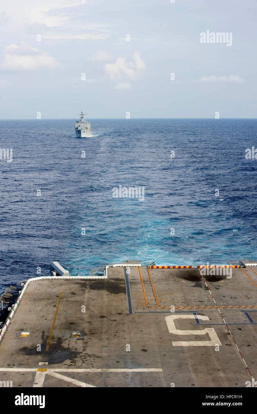 The amphibious dock landing ship USS Germantown (LPD 42), top, transits