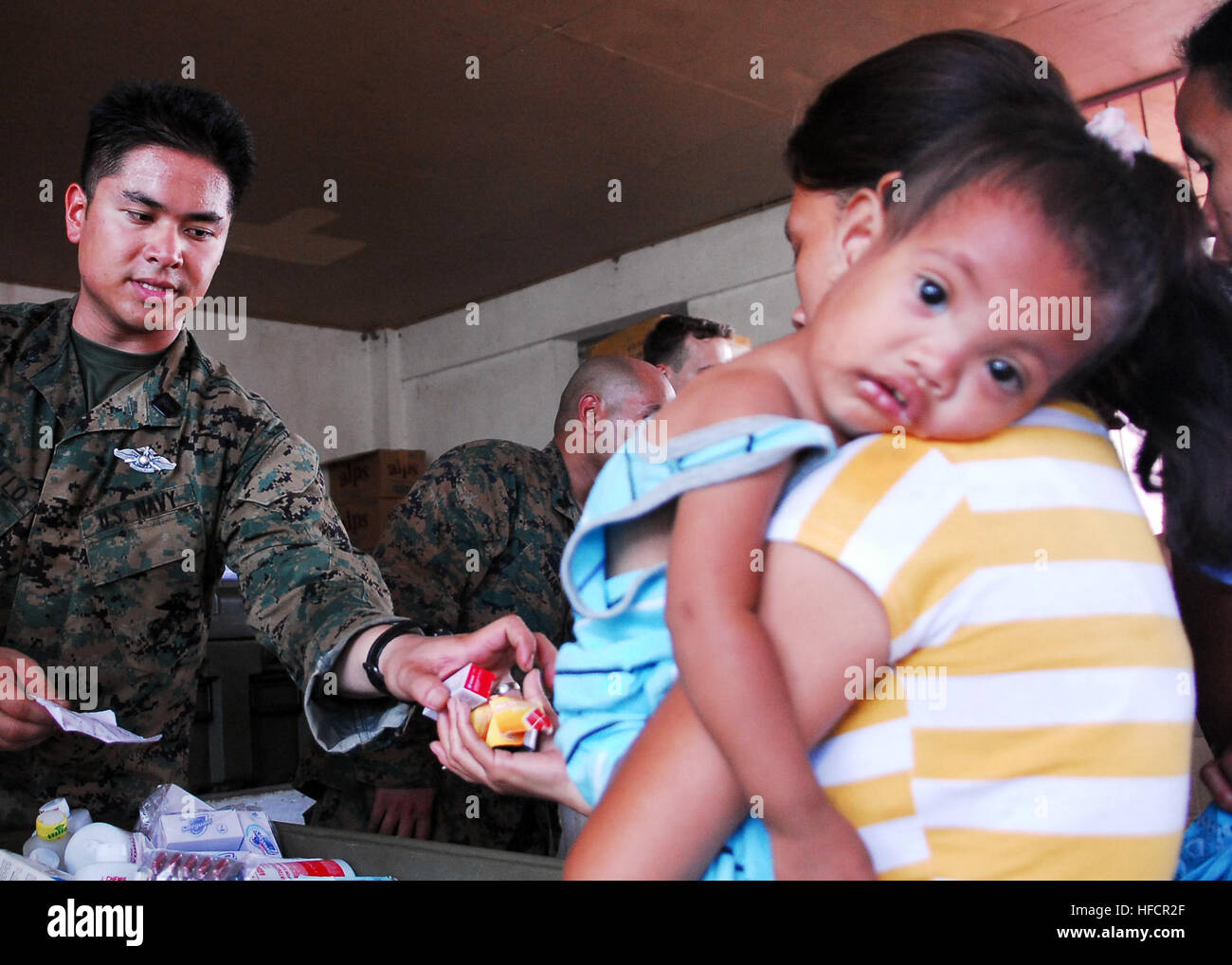 Petty Officer 2nd Class Joseph Castillo, from the Combat Logistics Battalion Health Service Support Team of the 31st Marine Expeditionary Unit, dispenses medication during a medical civil action project at San Juan Elementary School in Ternate, Philippines. The 31st MEU is operating with the forward-deployed Essex Amphibious Ready Group as part of Balikatan 2010, an annual, bilateral exercise designed to improve interoperability between the U.S. and Republic of the Philippines. Philippines activity 258800 Stock Photo