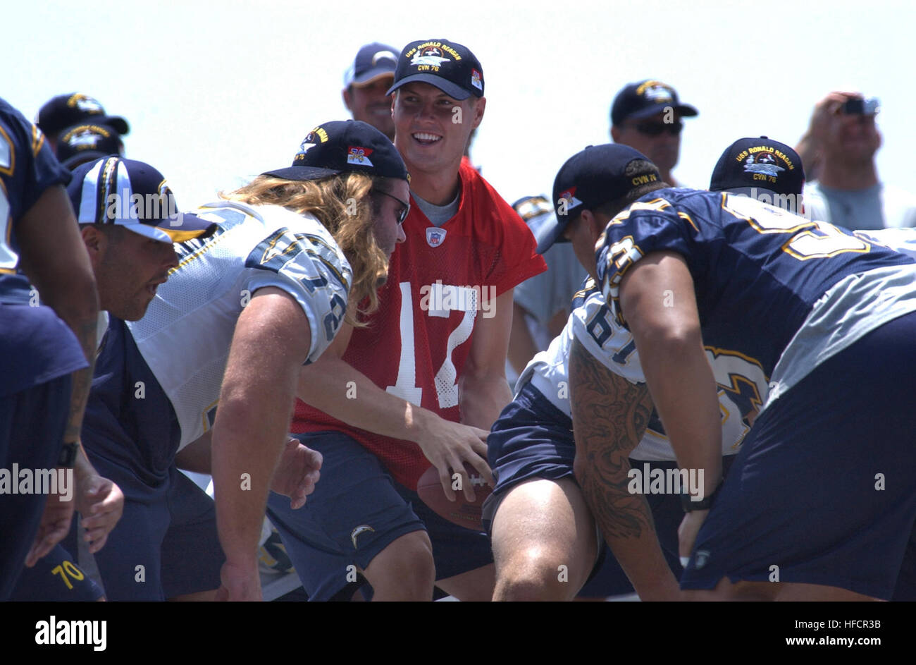 060811-N-4776G-095   San Diego, Calif. (Aug. 11, 2006) – Starting Quarterback for the National Football League (NFL) San Diego Chargers, Philip Rivers (17), takes the snap from Center, Nick Hardwick (61), during a light practice on the flight deck aboard USS Ronald Reagan (CVN 76). The Chargers held practice aboard the Navy's newest nuclear powered aircraft carrier in preparation for their first pre-season game against the Green Bay Packers, August 12. During pre-game ceremonies, a military appreciation game will involve Ronald Reagan Sailors and the unfurling of a giant American display flag. Stock Photo