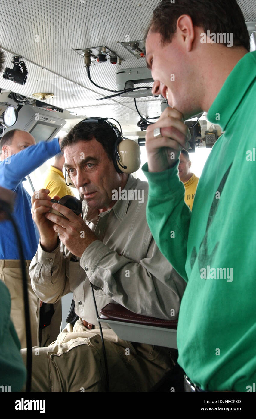040722-N-5621B-481 Pacific Ocean (July 22, 2004) Ð Aviation BoatswainÕs Mate Kevin Maguire instructs actor Tom Selleck on the function of the shipÕs sound-powered telephone system. Mr. Selleck used the system to speak with crew members in the below deck arresting gear rooms from the shipÕs bridge aboard USS Ronald Reagan's (CVN 76). Tom Selleck was aboard Reagan to welcome the shipÕs crew to Naval Air Station North Island, San Diego, Calif. Homeporting ceremonies for the NavyÕs newest and most technologically advanced aircraft carrier will host various dignitaries, including Nancy Reagan, memb Stock Photo