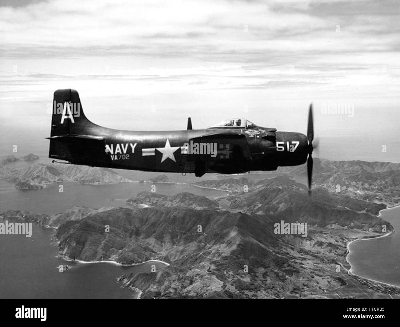 Photo #: 80-G-435040  Douglas AD-2 Skyraider attack plane (Bureau # 122343), of Attack Squadron 702 (VA-702)  Over the Japanese islands, after being launched on a routine flight from USS Boxer (CV-21) in September 1951. The ship was then en route to the Korean combat area.  Official U.S. Navy Photograph, now in the collections of the National Archives. AD-2 Skyraider of VA-702 over Japan in September 1951 Stock Photo