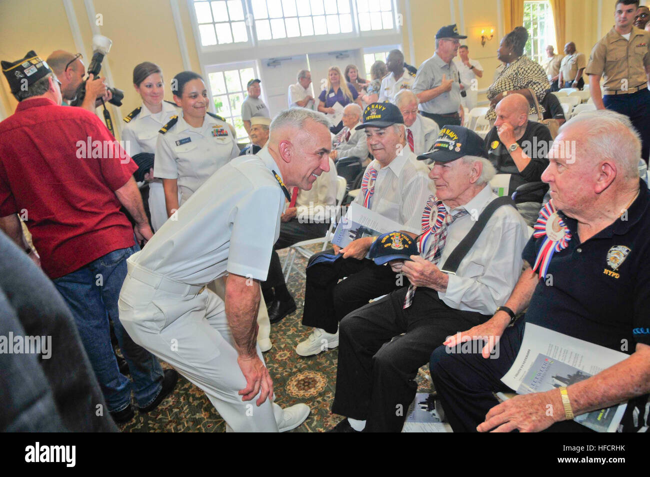 Capt. Chris Brunett, commanding officer of the amphibious transport dock ship USS New York (LPD 21), interacts with veterans and gives USS New York ball caps during a Salute to Veterans luncheon as part of Fleet Week Port Everglades. This is the 24th annual Fleet Week in Port Everglades, South Florida's annual celebration of the maritime services. (U.S. Navy photo by Mass Communication Specialist 2nd Class Cyrus Roson/Released) Port Everglades Fleet Week 2014 140430-N-YO707-272 Stock Photo