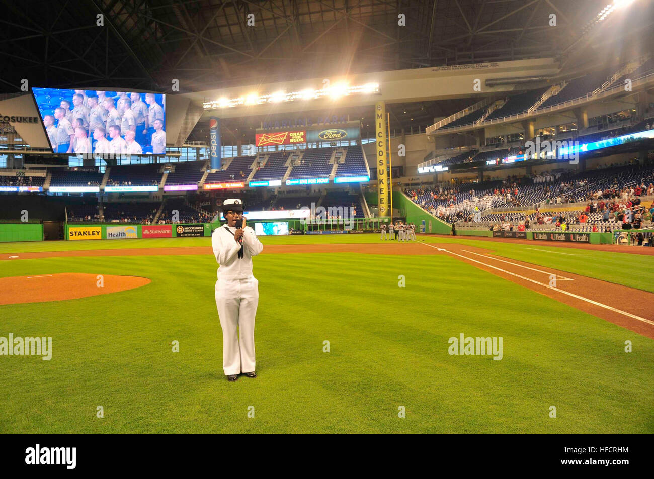Boatswain's Mate Seaman Marie Roberts from the amphibious transport dock ship USS New York (LPD 21) sings the national anthem during Military Appreciation Night at Marlins Park as part of Fleet Week Port Everglades. This is the 24th annual Fleet Week in Port Everglades, South Florida's annual celebration of the maritime services. (U.S. Navy photo by Mass Communication Specialist 2nd Class Cyrus Roson/Released) Port Everglades Fleet Week 2014 140430-N-YO707-404 Stock Photo