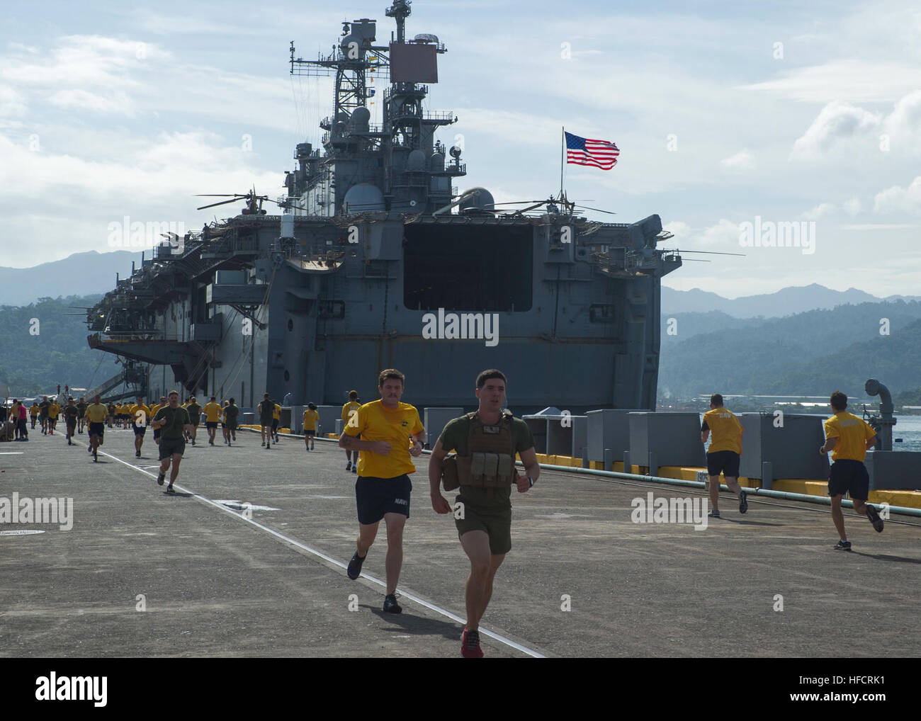 Sailors and Marines aboard USS Peleliu (LHA 5) participate in a 5K run ...