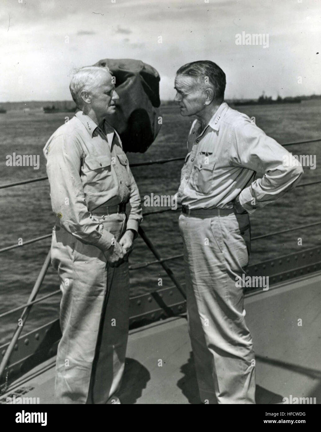 140219-N-ZZ999-101 Photo #: 80-G-34822 Admiral Chester W. Nimitz, USN, Commander in Chief Pacific and Pacific Ocean Areas (left), and Admiral William F. Halsey, USN, Commander, South Pacific Area and South Pacific Force, confer aboard USS Curtiss (AV-4) at 'Button' Naval Base, Espiritu Santo, New Hebrides, 20 January 1943. Official U.S. Navy Photograph Adm. Chester W. Nimitz and Adm. William F. Halsey 430120-N-ZZ999-101 Stock Photo