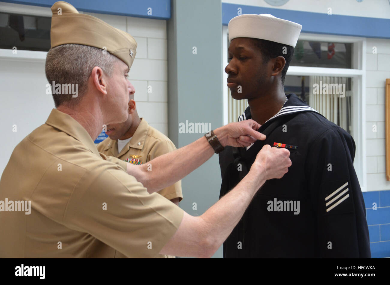 A Seaman Recruit at Recruit Training Command receives the Navy ...