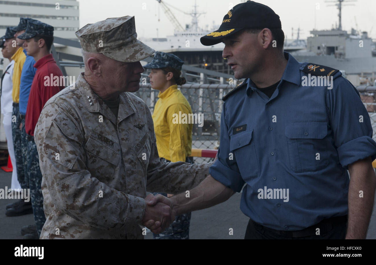 120711-N-SS993-155 PEARL HARBOR (July 11, 2012) U.S. Marine Maj. Gen. Kenneth Glueck, Commanding General, III Marine Expeditionary Force, shakes hands with Commander Combined Task Force (CTF) 176 Canadian Commodore Peter Ellis on the quarterdeck of the amphibious assault ship USS Essex (LHD 2).   Twenty-two nations, more than 40 ships and submarines, more than 200 aircraft and 25,000 personnel are participating in RIMPAC exercise from June 29 to Aug. 3, in and around the Hawaiian Islands.  The world's largest international maritime exercise, RIMPAC provides a unique training opportunity that h Stock Photo
