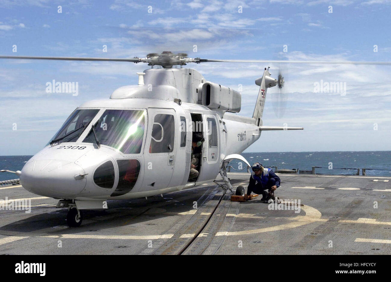 A Royal Thai Navy (RTN) Sikorsky S-76B helicopter, is secured to the flight deck onboard the USS CURTS (FFG 38) during Cooperation Afloat Readiness and Training (CARAT) Exercise 2001. Royal Thai Navy Sikorksy S-76B Stock Photo