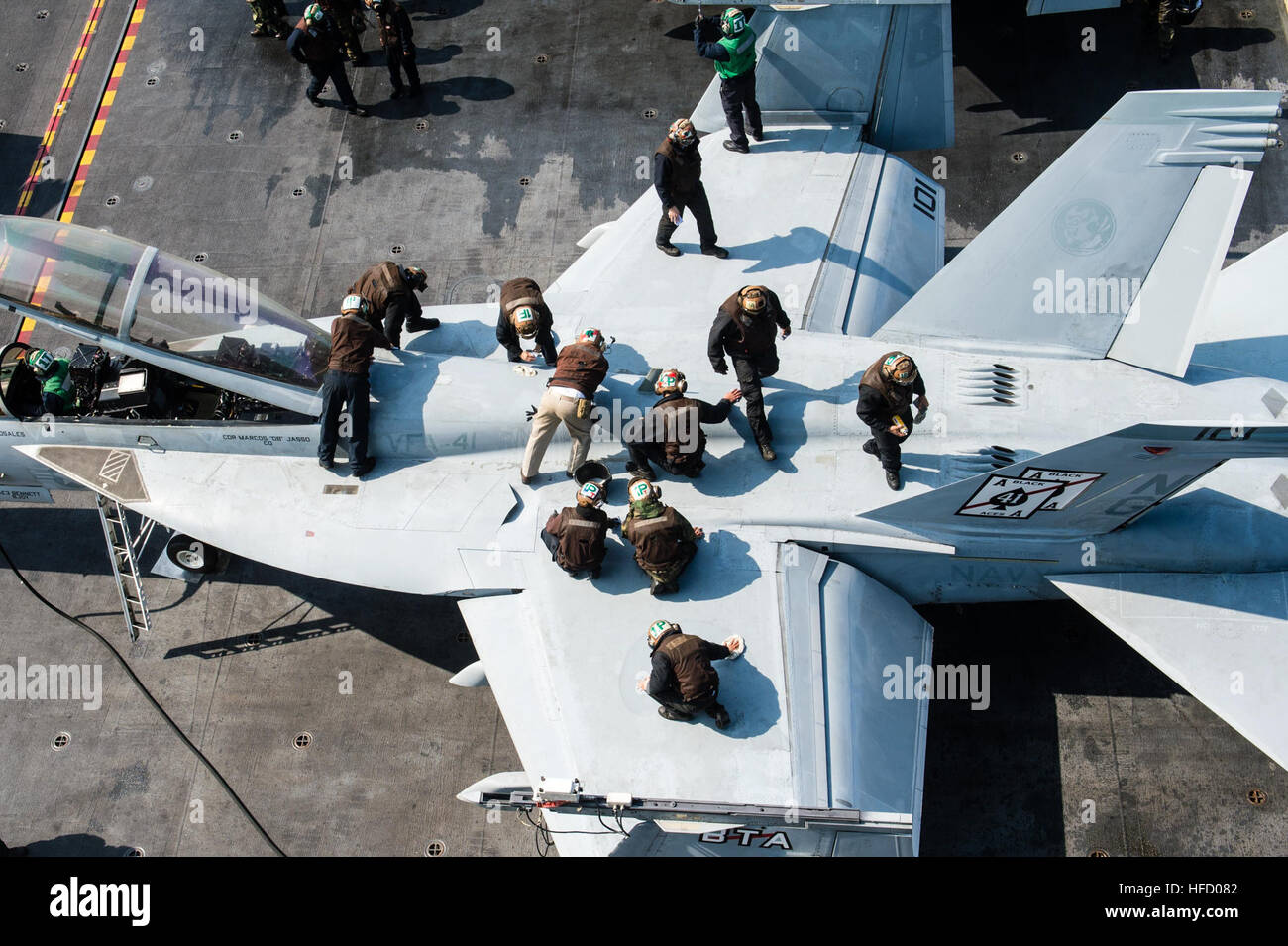 WATERS SURROUNDING THE KOREAN PENINSULA (March 23, 2016) Sailors clean an F/A-18F Super Hornet assigned to the Black Aces of Strike Fighter Squadron (VFA) 41 on the flight deck of the aircraft carrier USS John C. Stennis (CVN 74). Providing a ready force supporting security and stability in the Indo-Asia-Pacific, John C. Stennis is operating as part of the Great Green Fleet on a regularly scheduled U.S. 7th Fleet deployment. (U.S. Navy photo by Mass Communication Specialist 3rd Class Andre T. Richard/Released) 160323-N-XX566-087  Join the conversation: http://www.navy.mil/viewGallery.asp http: Stock Photo