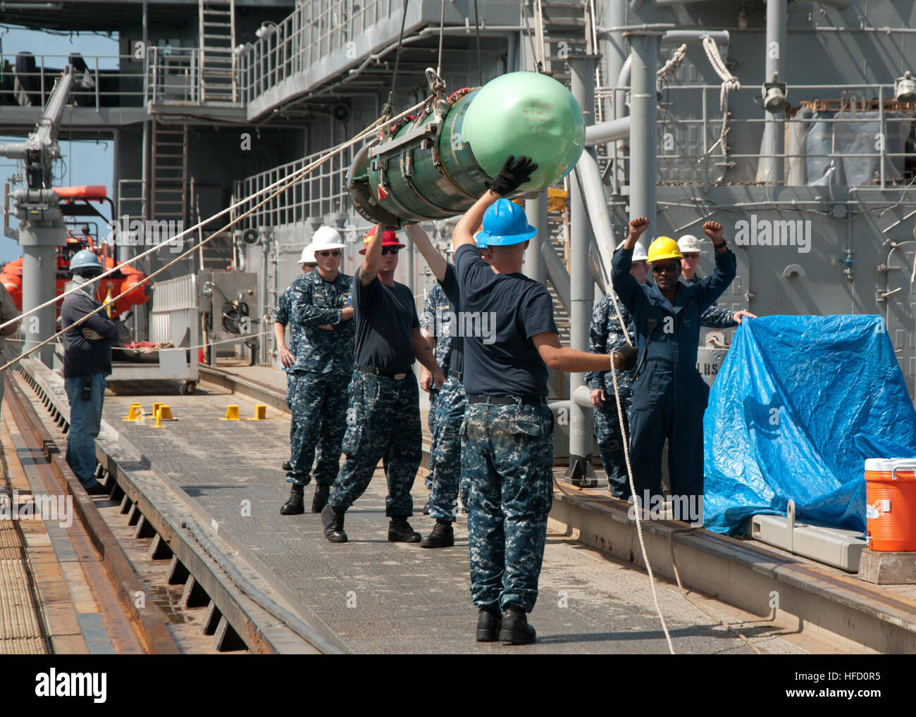 Sailors aboard the submarine tender USS Frank Cable guide a Mark 48 ...