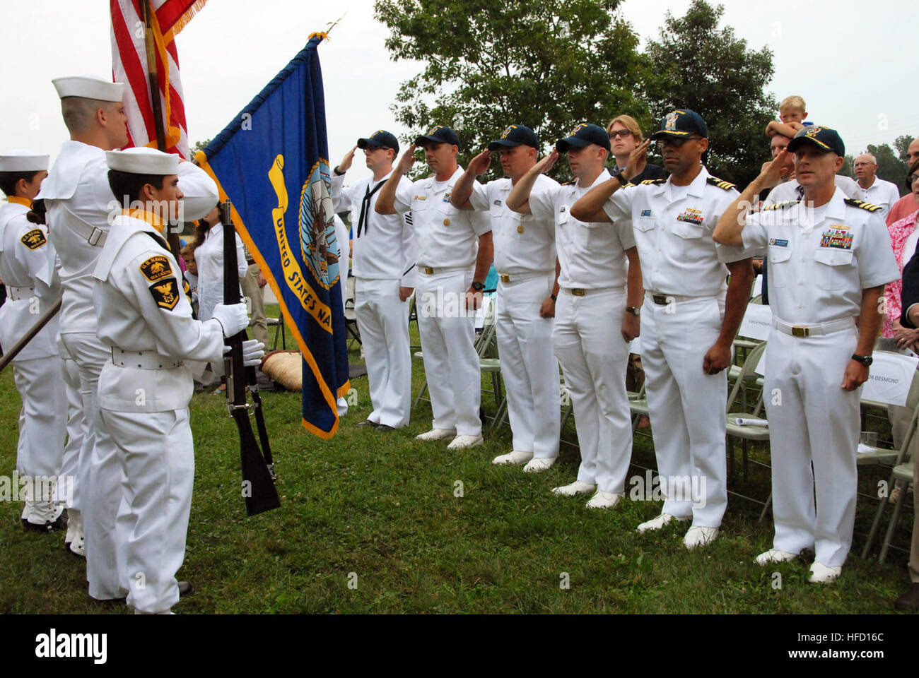 150829-N-ZZ999-991 MONROE, Mich. (Aug. 29 2015) – Sailors assigned to Littoral Combat Ship Crew 103 Pre-Commissioning Unit Detroit render honors as members of a local U.S. Navy Sea Cadet Corps present the colors at the River Raisin Battlefield Park in Monroe, Mich., Aug. 29 as part of Navy Week Detroit. Navy Weeks focus a variety of assets, equipment and personnel on a single city for a week-long series of engagements designed to bring America's Navy closer to the people it protects, in cities that don't have a large naval presence. (U.S. Navy photo by Mass Communication Specialist 1st Class D Stock Photo