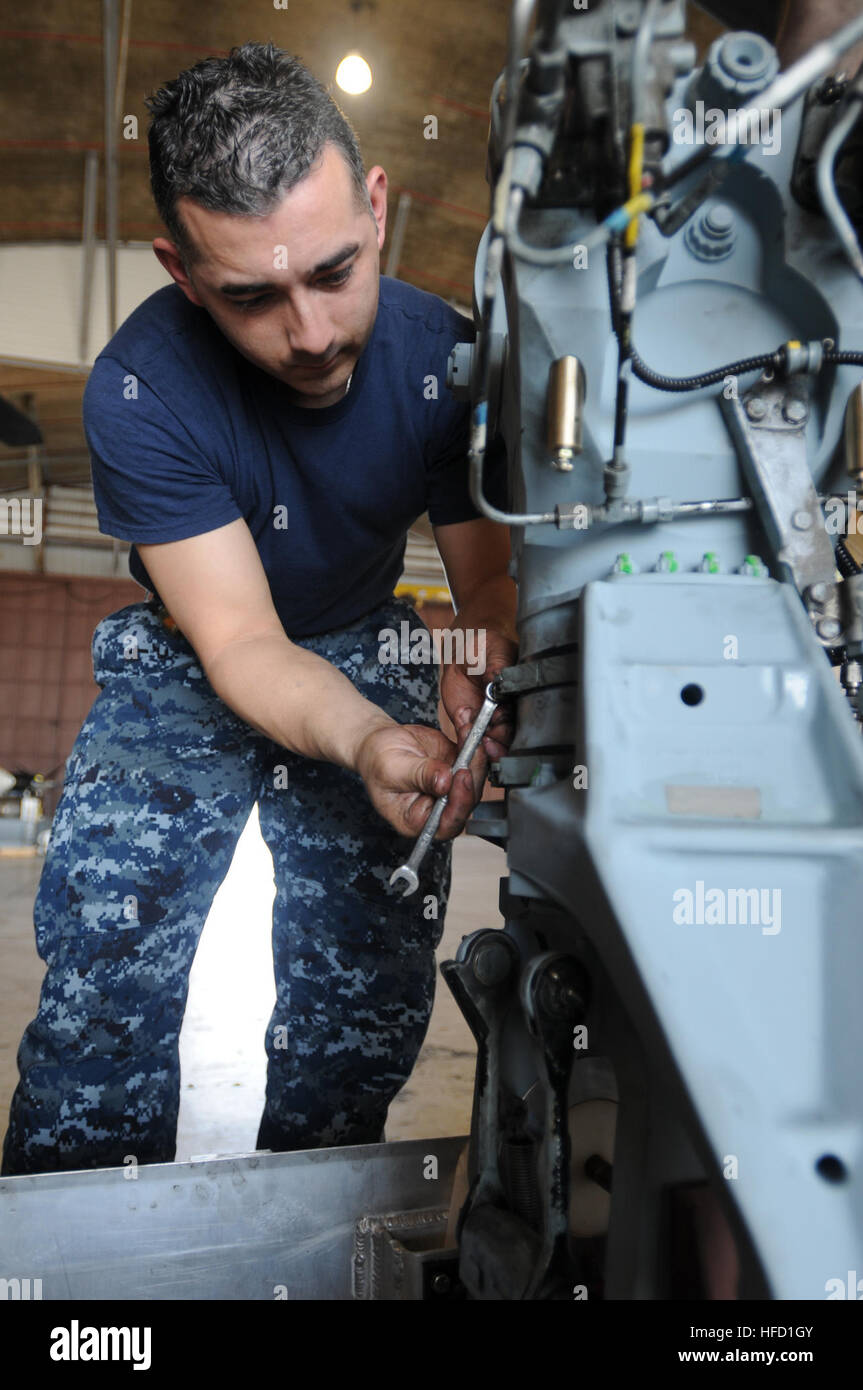 Petty Officer 2nd Class Timothy Morales, assigned to Helicopter Mine Squadron 15, does maintenance on the sleeve and spindle assembly for an MH-53E Sea Dragon at the U.S. Naval Station Guantanamo Bay airfield, Feb. 1. HM-15 is at Guantanamo supporting Operation Unified Response following the 7.0 magnitude earthquake in Haiti, Jan. 12. Sailor fixes helicopter used in Haiti relief efforts 249261 Stock Photo