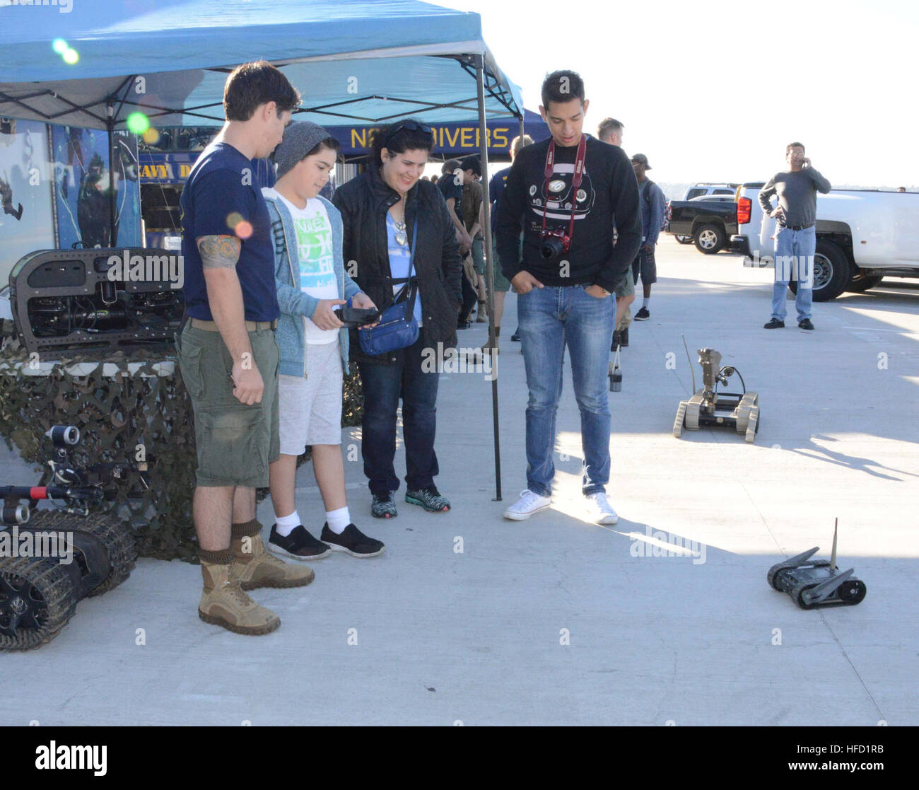 151111-N-NH654-010 SAN DIEGO (Nov. 11, 2015) Explosive Ordnance Disposal 2rd Class Louis Velarde explains to a visitor how to operate a robot during the Salute to Service Festival.  Explosive Ordnance Disposal Mobile Unit 11 is participating in the Salute to Service Festival, which is held annual on the USS Midway on Veterans Day. (U.S. Navy photo by Lieutenant Patricia Kreuzberger/Released) Salute to Service 151111-N-NH654-010 Stock Photo