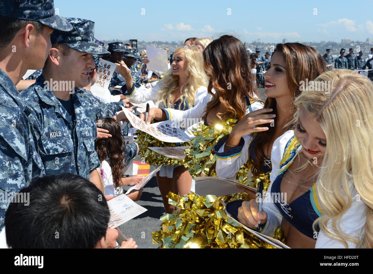 Sailors aboard the aircraft carrier USS Ronald Reagan (CVN 76) receive autographs from the San Diego Chargers cheerleaders during a simulated practice on the flight deck. Ronald Reagan is currently moored and home-ported at Naval Base Coronado. (U.S. Navy photo by Mass Communication Specialist 3rd Class Timothy Schumaker/Released) San Diego Chargers visit USS Ronald Reagan 130828-N-UK306-260 Stock Photo