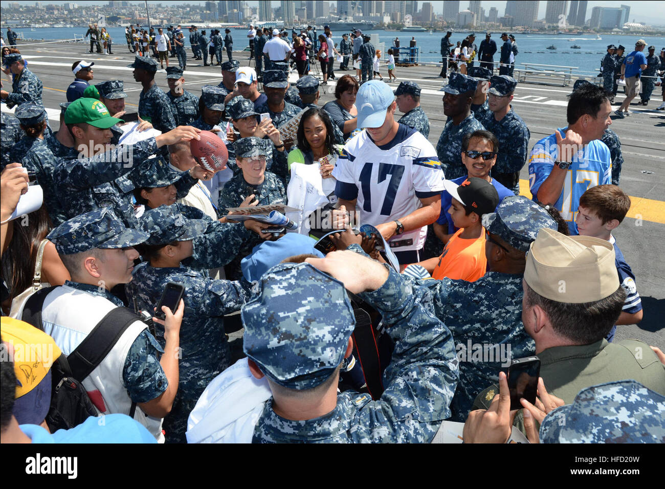 Sailors aboard the aircraft carrier USS Ronald Reagan (CVN 76) wait for autographs from San Diego Chargers quarterback Philip Rivers after a simulated practice on the flight deck. Ronald Reagan is currently moored and home-ported at Naval Base Coronado. (U.S. Navy photo by Mass Communication Specialist 3rd Class Timothy Schumaker/Released) San Diego Chargers visit USS Ronald Reagan 130828-N-UK306-282 Stock Photo