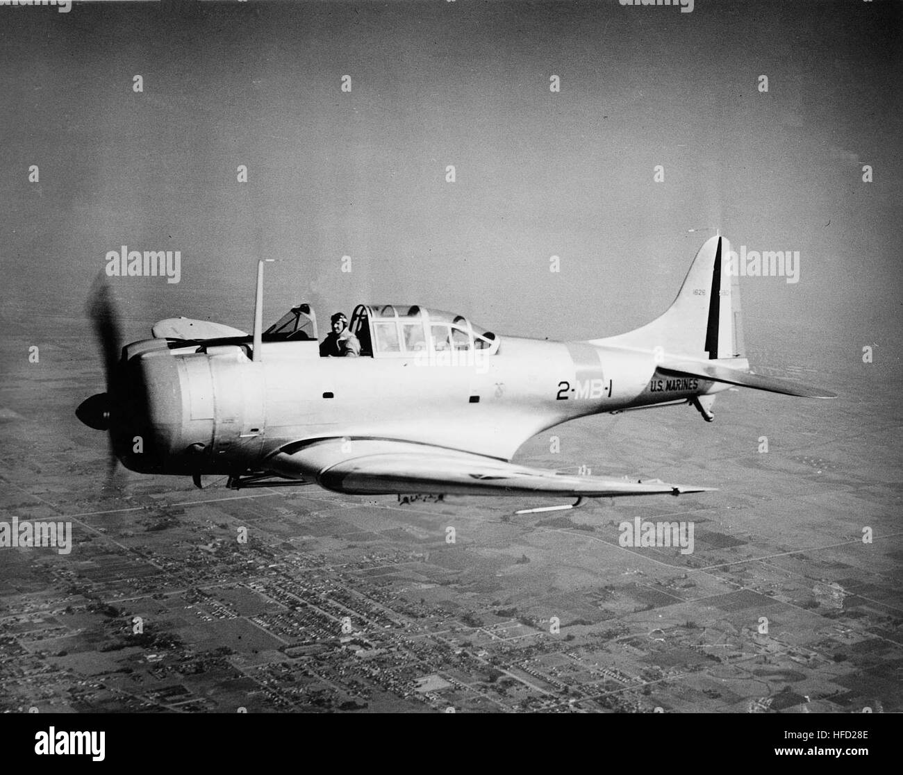 A Petty Officer First Class sets up a transit level for elevation ...