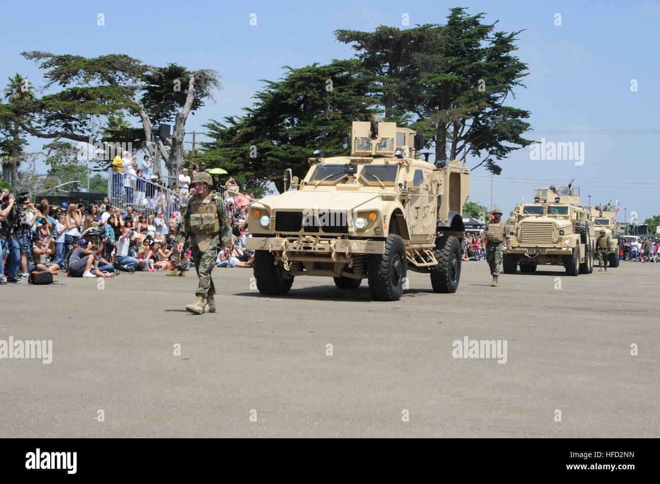 Seabees from Naval Mobile Construction Battalion 3’s Convoy Security Element team drive Mine Resistant Ambush Protected Vehicles in front of a crowd during Seabee Days, here on the Port Hueneme ceremonial grinder July 23. This was the 24th Seabee Days held in Port Hueneme since 1986 and is a two day celebration honoring the men and women of the Navy’s elite construction force. Seabees are an expeditionary element of U.S. Naval forces providing construction, engineering and security services in support of national strategy, naval power projection, humanitarian assistance and contingency operati Stock Photo
