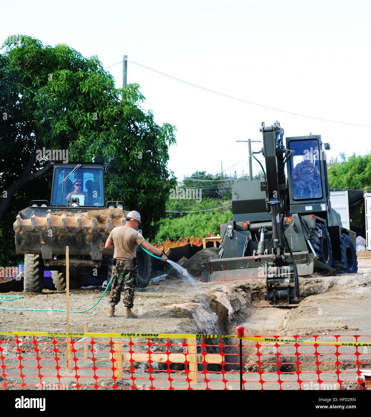 NAVAL STATION GUANTANAMO BAY, Cuba (Nov. 22, 2011) – Sailors from Naval Mobile Construction Battalion 23, use front end loaders and excavators to establish a solid foundation for a new 800 square foot latrine at the Naval Station Guantanamo Bay golf center.  NMCB 23 is deployed in support of Joint Task Force Guantanamo and U.S. Naval Station Guantanamo Bay construction projects. (JTF Guantanamo photo by U.S. Navy Mass Communications Specialist 2nd Class Kilho Park) UNCLASSIFIED – Cleared for public release. For additional information contact JTF Guantanamo PAO 011-5399-3649; DSN 660-3649 www.j Stock Photo