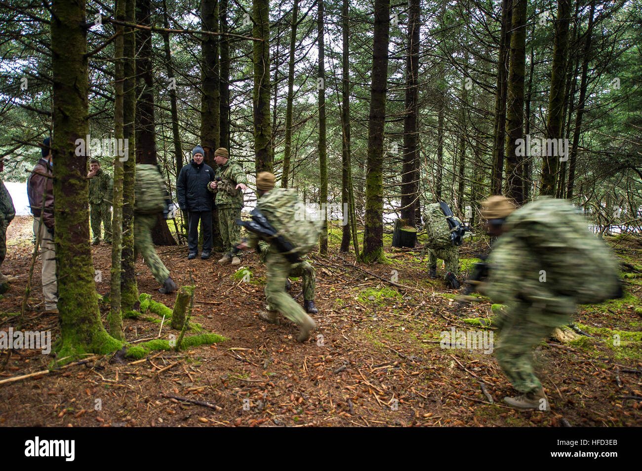 A senior Navy official observes training, a promotion and awards ...