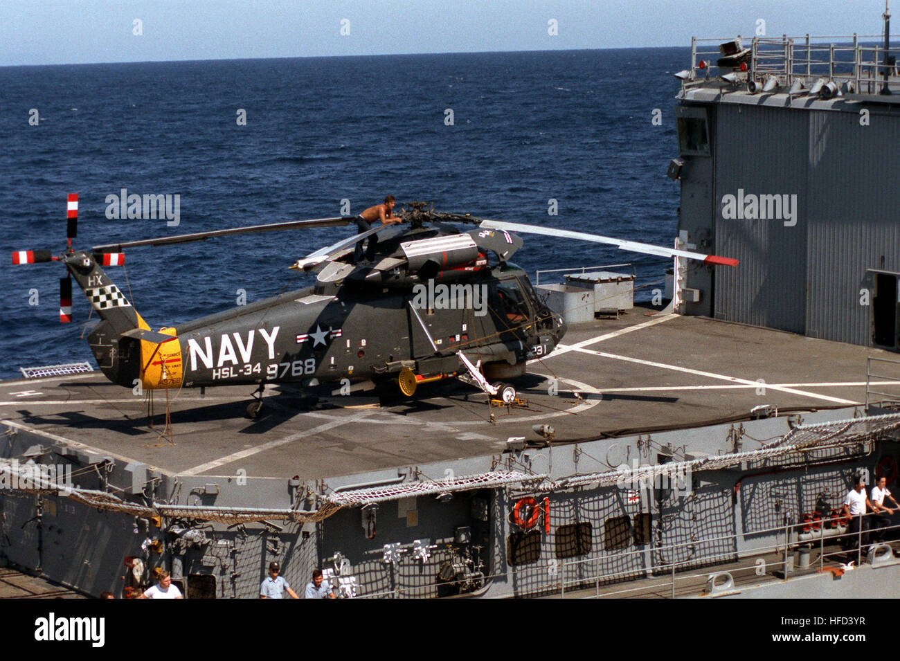 A Light Helicopter Anti-submarine Squadron 34 (HSL-34) SH-2F Seasprite helicopter sits on the flight deck of the destroyer USS DEYO (DD-989). SH-2F HSL-34 on USS Deyo (DD-989) 1982 Stock Photo