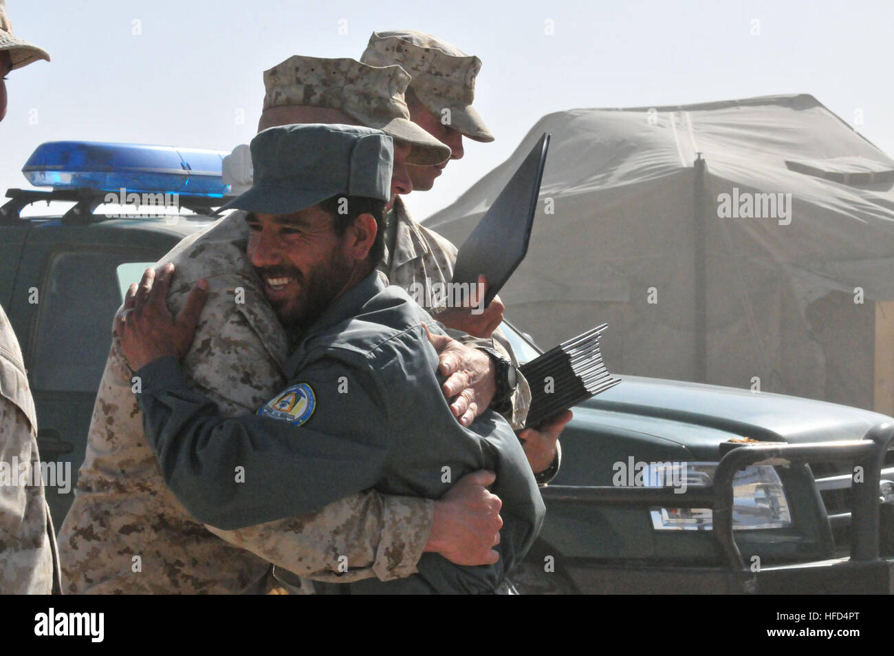 A U.S Marine Corps drill instructor congratulates a graduate of Afghan National Police Class 2010-02 after the class' graduation ceremony held at Camp Leatherneck, Afghanistan on Wednesday, March 31. The Marines are mentoring the ANP recruits as part of the NATO ISAF partnership with Afghanistan aimed at developing self-sufficient security forces for the country. (U.S. Navy Photo by Petty Officer 2nd Class Maria A. Garza) Afghanistan Uniform Police graduate 84 new recruits 268750 Stock Photo