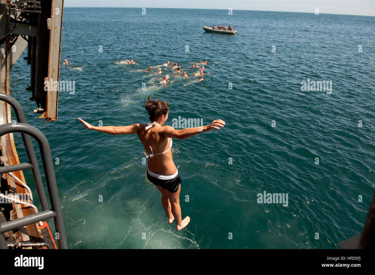 Sailors and marines take the opportunity during a swim call to leap