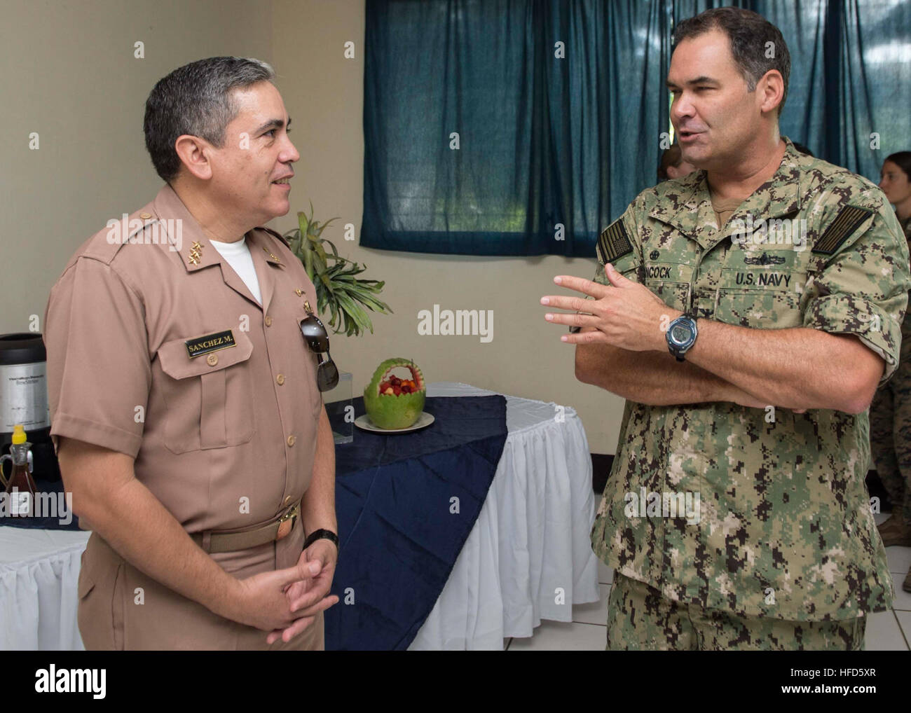 Southern Partnership Station Joint High Speed Vessel 2014 (SPS-JHSV 14) Mission Commander Capt. Sam Hancock, speaks with Guatemalan Capitán de navío Erick A. Sanchez Muniz, prior to a breakfast at the Brigada de Infanteria de Marina during Southern Partnership Station 2014. Southern Partnership Station 2014 is a U.S. Navy deployment focused on subject matter expert exchanges with partner nation militaries and security forces. U.S. Naval Forces Southern Command and U.S. 4th Fleet employ maritime forces in cooperative maritime security operations in order to maintain access, enhance interoperabi Stock Photo