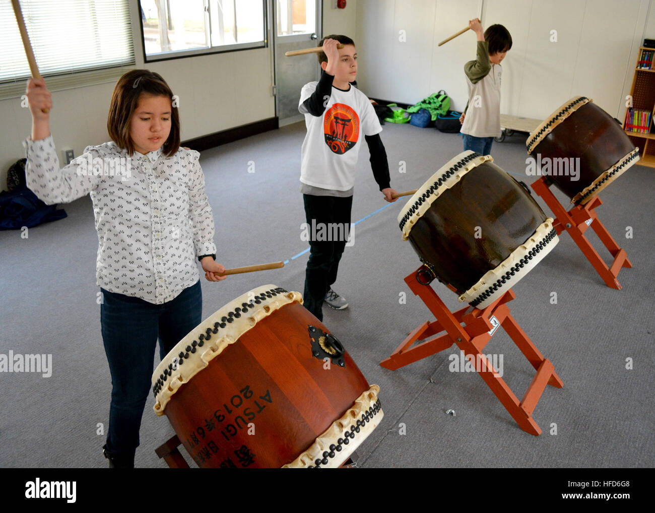 140221-N-OX321-137 NAVAL AIR FACILITY ATSUGI, Japan (Feb. 21, 2014) – Shirley Lanham Elementary School students practice taiko for an upcoming performance at the Japan-U.S. Sports Festival in Ayase, Japan. The event consists of the SLES taiko players, a tea ceremony conducted by Naval Air Facility Atsugi community members, and soccer and baseball games. (U.S. Navy photo by Mass Communication Specialist 2nd Class Kegan E. Kay/Released) Sports festival 140221-N-OX321-137 Stock Photo