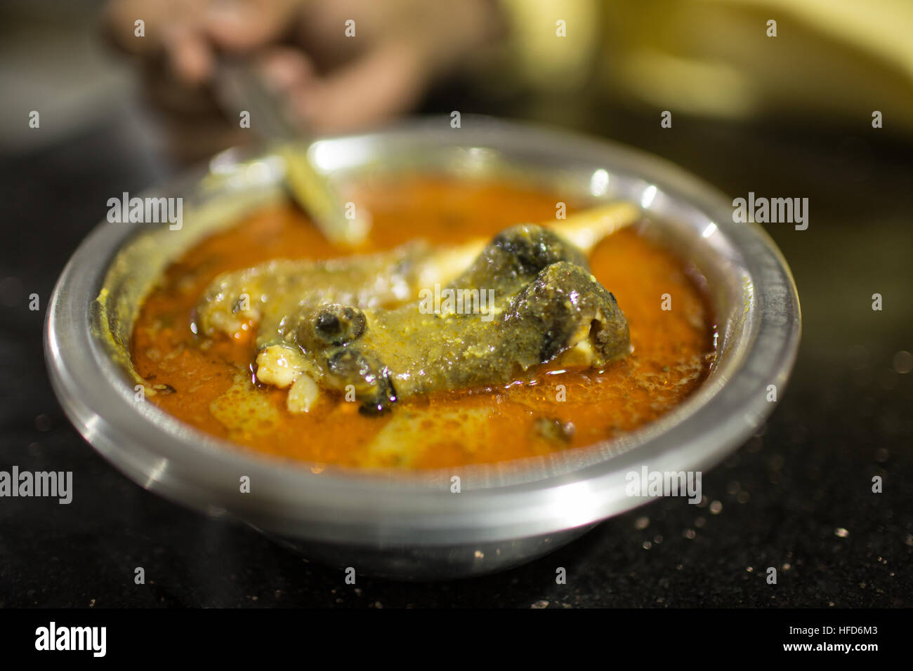 Close-up of Mutton Paya Soup served in a small stainless steel bowl. Paya is a soup made with lamb trotters and spices Stock Photo