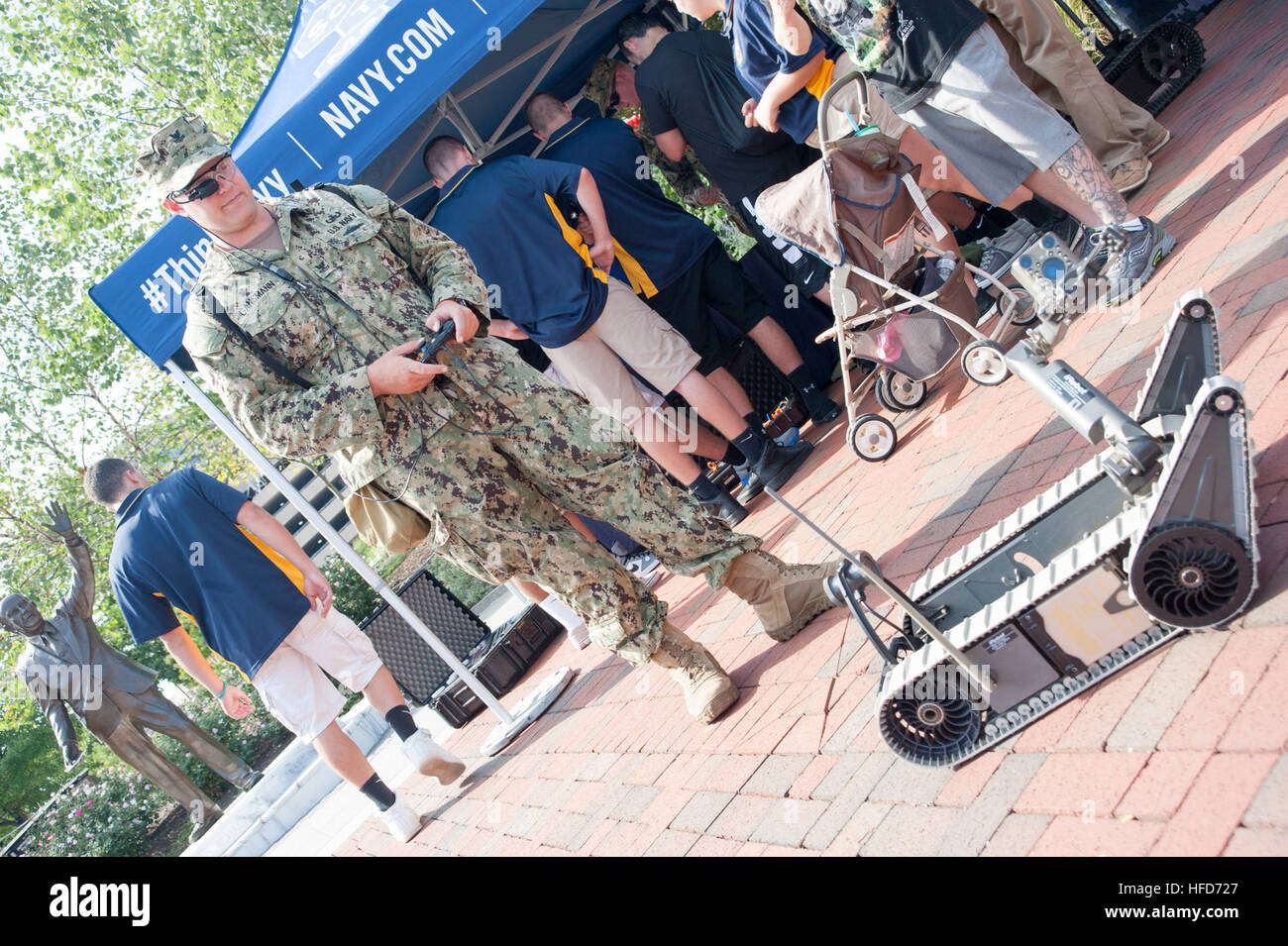 Explosive Ordnance Disposal Technician 2nd Class Clifford C. Jordan, of Explosive Ordnance Disposal Mobile Unit Six (EODMU-6), describes the capabilities of the Qinetiq Talon Explosive Ordnance Disposal robot to cadets from the Colts Neck High School Naval Junior Reserve Officers' Training Corps as part of Star-Spangled Spectacular. Star-Spangled Spectacular will run from Sept. 10-16, 2014, and celebrates the bicentennial of the Battle of Baltimore, which provided the backdrop for Francis Scott Key's famous poem, 'Defense of Fort McHenry,' which later became America's national anthem. (U.S. Na Stock Photo