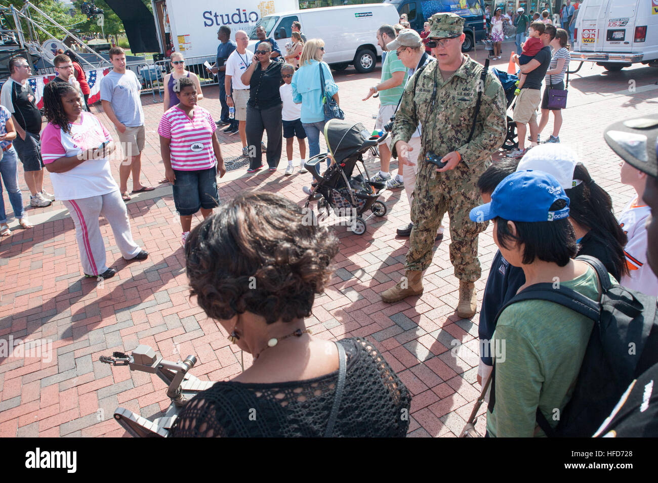 Explosive Ordnance Disposal Technician 2nd Class Clifford C. Jordan, of Explosive Ordnance Disposal Mobile Unit Six (EODMU-6), describes the capabilities of the Qinetiq Talon Explosive Ordnance Disposal robot to cadets from the Colts Neck High School Naval Junior Reserve Officers' Training Corps as part of Star-Spangled Spectacular. Star-Spangled Spectacular will run from Sept. 10-16, 2014, and celebrates the bicentennial of the Battle of Baltimore, which provided the backdrop for Francis Scott Key's famous poem, 'Defense of Fort McHenry,' which later became America's national anthem. (U.S. Na Stock Photo