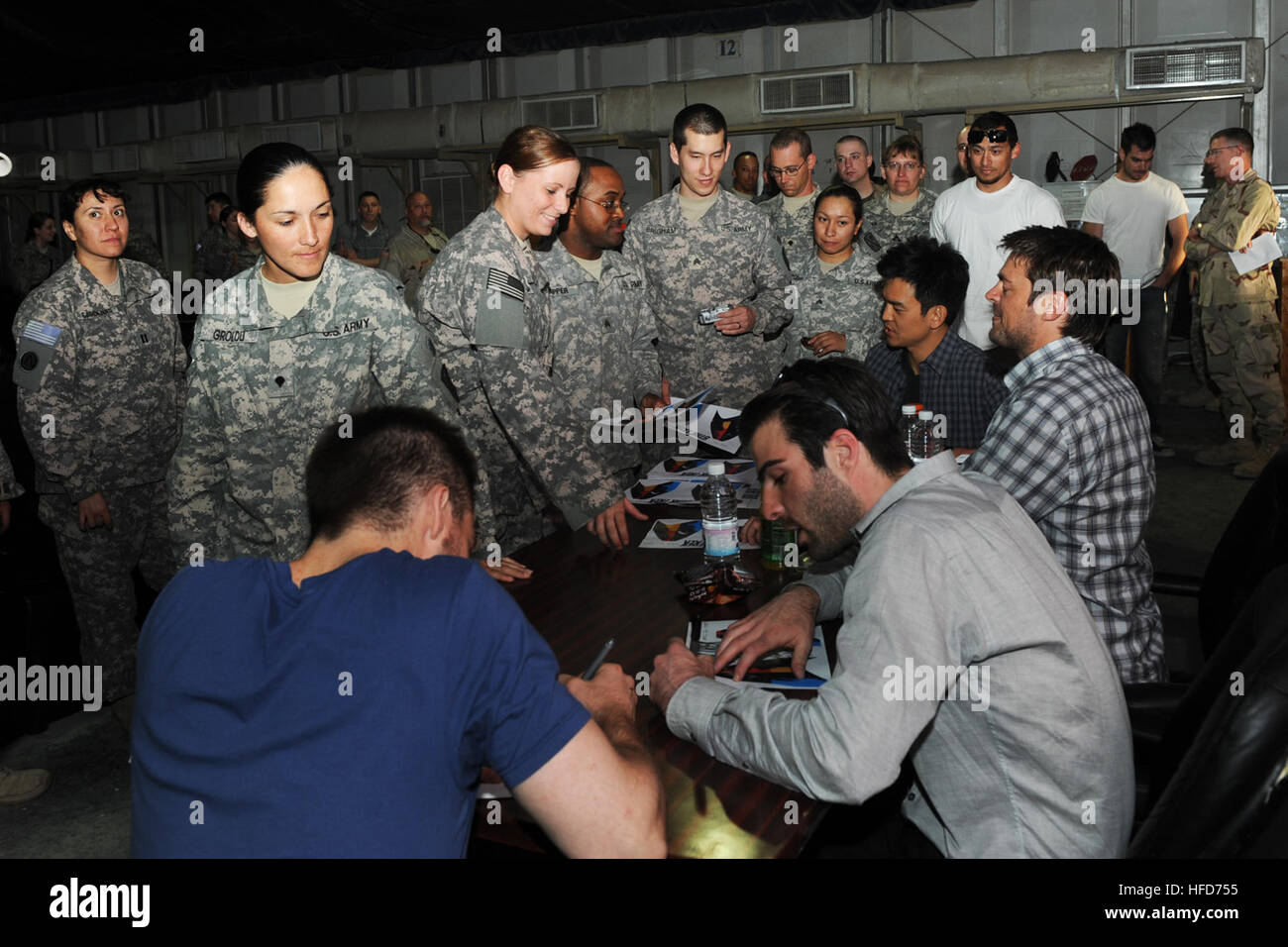 Cast members from the new Star Trek movie Chris Pine (from left), Zachary Quinto, Karl Urban and John Cho sign autographs on a base in the Middle East on April 11. The cast spent the day meeting with military personnel from the different bases. Star Trek cast 1 Stock Photo