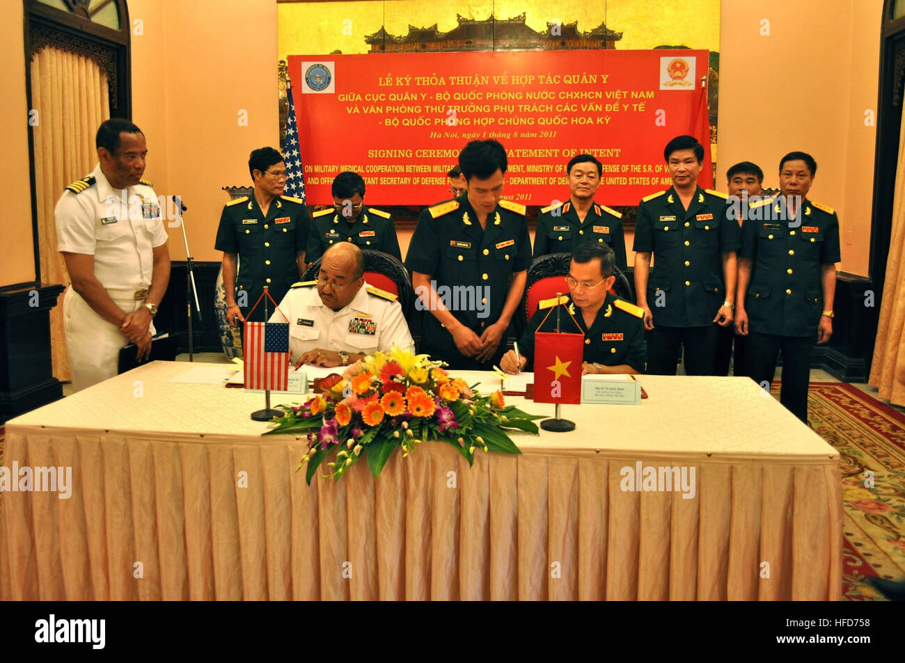 The U.S. Navy Vice Adm. Adam M. Robinson Jr. signs a statement of intent on military medical cooperation with Sr. Col. Vu Quoc Binh, director general of the Vietnamese Ministry of National Defense's Military Medical Department. U.S. Embassy Chargé d'Affaires Claire Pierangelo and Deputy Minister of National Defense Lt. Gen. Le Huu Duc witnessed the signing. The signing ceremony represents continued progress on a key area of military cooperation outlined by former Secretary of Defense Robert Gates and Minister of Defense Phung Quang Thanh in October 2010.  (Photo by: Capt. Cappy Surette) Statem Stock Photo