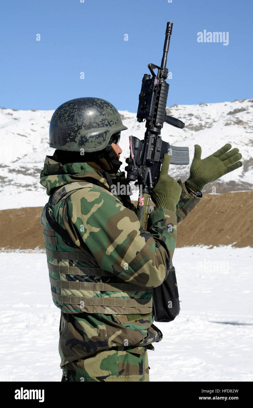 An Afghan National Army Commando reloads his M4 carbine during battle drills at Camp Morehead, Kabul province, Afghanistan, Feb. 28. The ANA Commandos conduct counterinsurgency operations throughout Afghanistan to provide stability in the region. (U.S. Navy photo by Mass Communication Specialist 3rd Class Sebastian McCormack / Not Released) Afghan National Army commandos battle drills 120228-N-MF277-045 Stock Photo