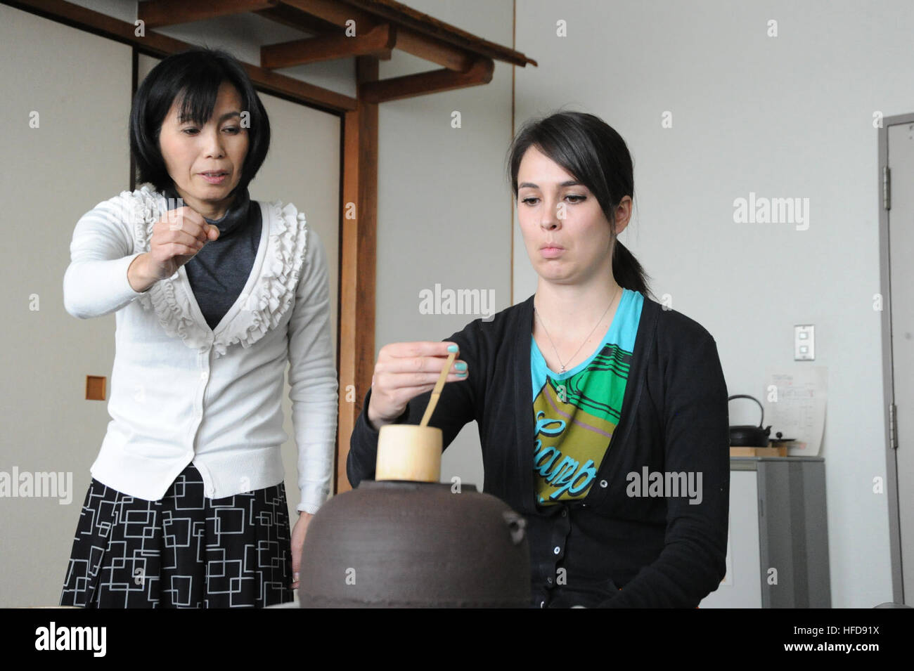 120420-N-TO330-246 AYASE, Japan (Apr. 20, 2012) – Sumie Maruyama (left) instructs her student, Mary Anna Fox, on how to properly hold the water ladle during a tea ceremony class held at the Japan Maritime Self Defense Force bachelor housing on Naval Air Facility (NAF) Atsugi. Maruyama works in the installation's Host Nation Relations office where she acts as a liaison between the command and surrounding communities fostering good relations between NAF Atsugi and local citizens through community relation opportunities. (U.S. Navy photo by Mass Communication Specialist 3rd Class Vivian Blakely/R Stock Photo