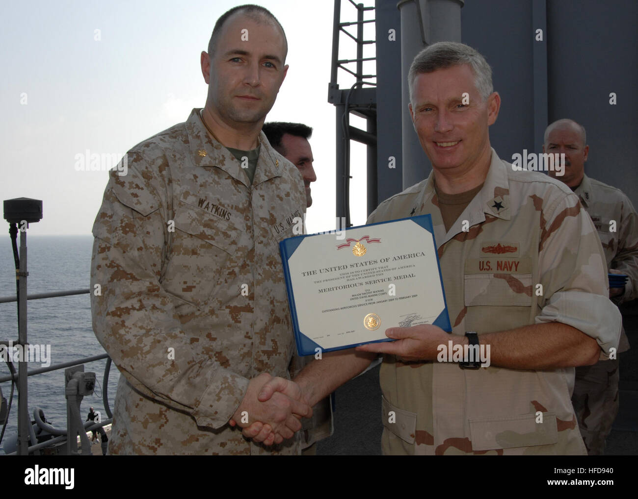 U.S. Navy Rear Adm. Terence McKnight, commander of Combined Task Force (CTF) 151, presents awards to his staff aboard USS Boxer (LHD 4) April 4, 2009, in the Gulf of Aden. Boxer is the flagship for CTF 151, a multinational task force conducting counterpiracy operations in and around the Gulf of Aden, the Arabian Sea, the Indian Ocean and the Red Sea. (U.S. Navy photo by Mass Communication Specialist 2nd Class Laura A. Moore/Released) TerenceMcKnightonduty Stock Photo