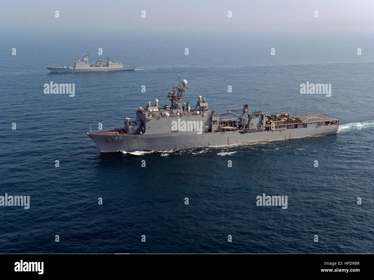 The amphibious dock landing ship USS Ashland (LSD 48), front, transits the East China Sea with the South Korean destroyer ROKS Dae Jo-yeong (DDH 977) during a photo exercise March 27, 2014. The Ashland was part of the Bonhomme Richard Amphibious Ready Group and was participating in exercise Ssang Yong 14, a combined U.S.-South Korean combat readiness and joint/combined interoperability exercise designed to advance South Korean command and control capabilities through amphibious operations. (U.S. Navy photo by Mass Communication Specialist 2nd Class Michael Achterling/Released) The amphibious d Stock Photo