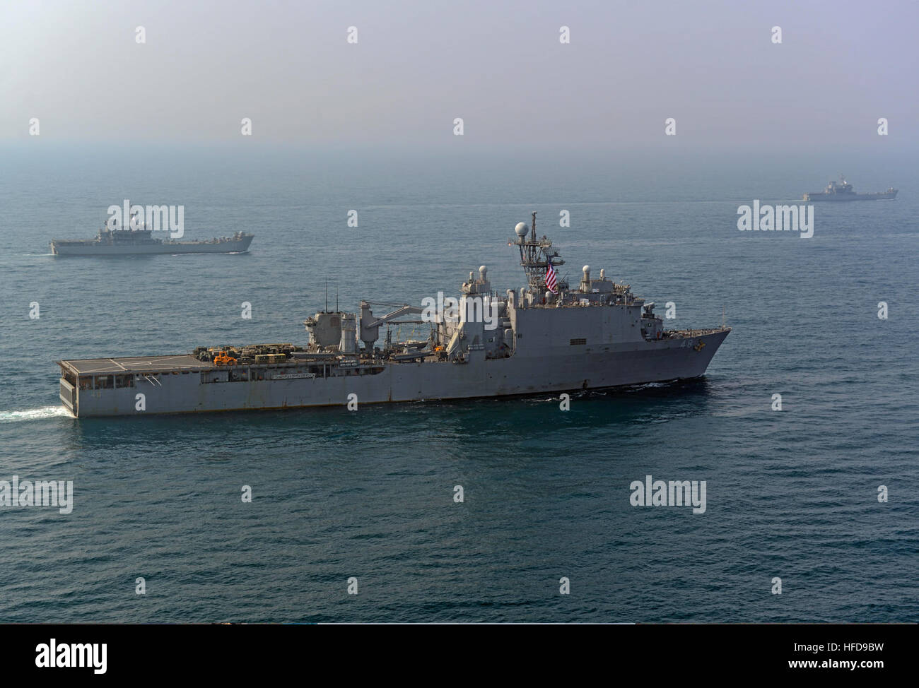 The amphibious transport dock ship USS Denver (LPD 9), front, and other ships assigned to the Bonhomme Richard Amphibious Ready Group are underway with Republic of Korea Navy ships during a photo exercise in the East China Sea March 27, 2014. The Denver was participating in exercise Ssang Yong 14, a combined U.S.-South Korean combat readiness and joint/combined interoperability exercise designed to advance South Korean command and control capabilities through amphibious operations. (U.S. Navy photo by Mass Communication Specialist 2nd Class Michael Achterling/Released) The amphibious transport Stock Photo
