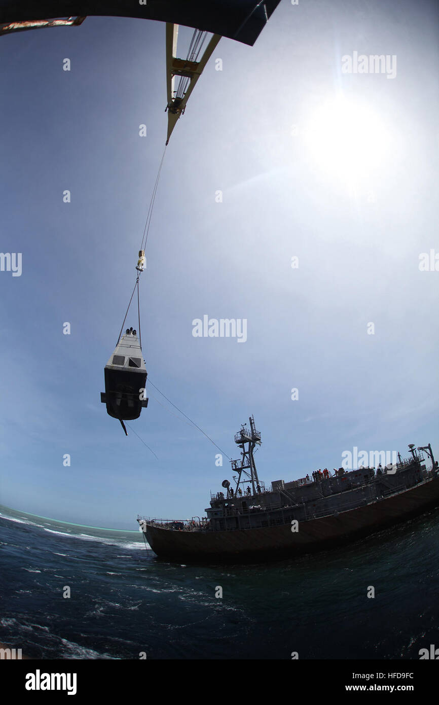 SULU SEA (Feb. 25, 2013) A crane from the U.S. Navy contracted ship M/V Jascon 25 safely removes the exhaust funnel structure from the mine countermeasures ship USS Guardian (MCM 5). Guardian ran aground on the Tubbataha Reef Jan. 17. The funnel's removal was a milestone in the dismantling process of the Guardian. The U.S. Navy and contracted salvage teams are safely dismantling and removing the ship from Tubbataha Reef. The U.S. Navy continues to work in close cooperation with the Philippine authorities to safely dismantle Guardian from the reef while minimizing environmental effects. (U.S. N Stock Photo