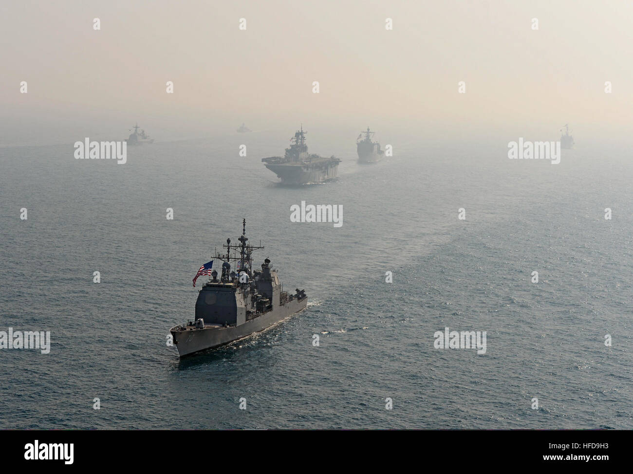 The guided missile cruiser USS Lake Erie (CG 70), front, transits the East China Sea with ships assigned to the Bonhomme Richard Amphibious Ready Group and Republic of Korea Navy ships during a photo exercise March 27, 2014. The Lake Erie was participating in exercise Ssang Yong 14, a combined U.S.-South Korean combat readiness and joint/combined interoperability exercise designed to advance South Korean command and control capabilities through amphibious operations. (DoD photo by Mass Communication Specialist 2nd Class Michael Achterling, U.S. Navy/Released) The guided missile cruiser USS Lak Stock Photo