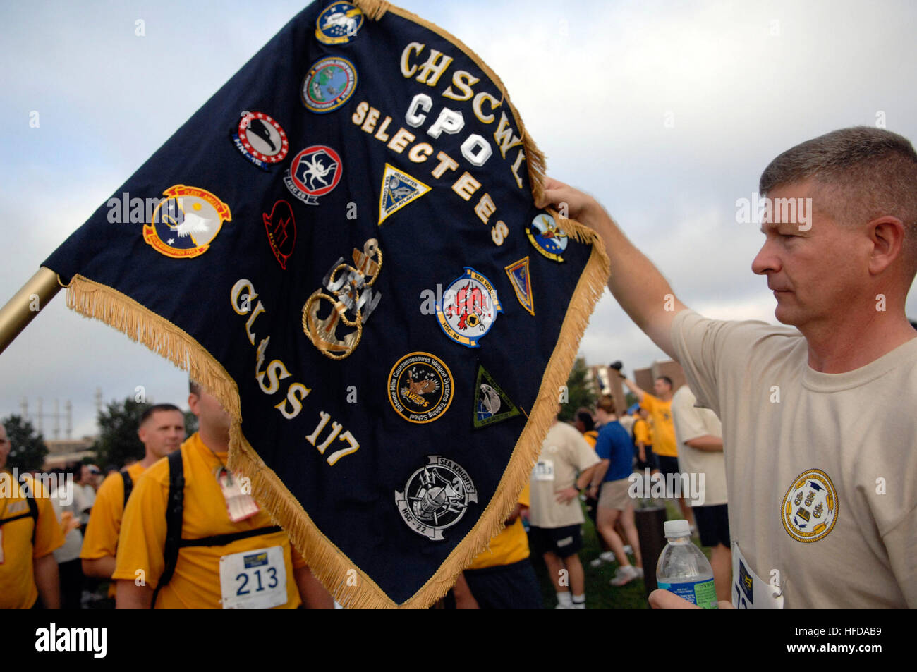 Master Chief Petty Officer of the Navy Rick West looks at guidons for