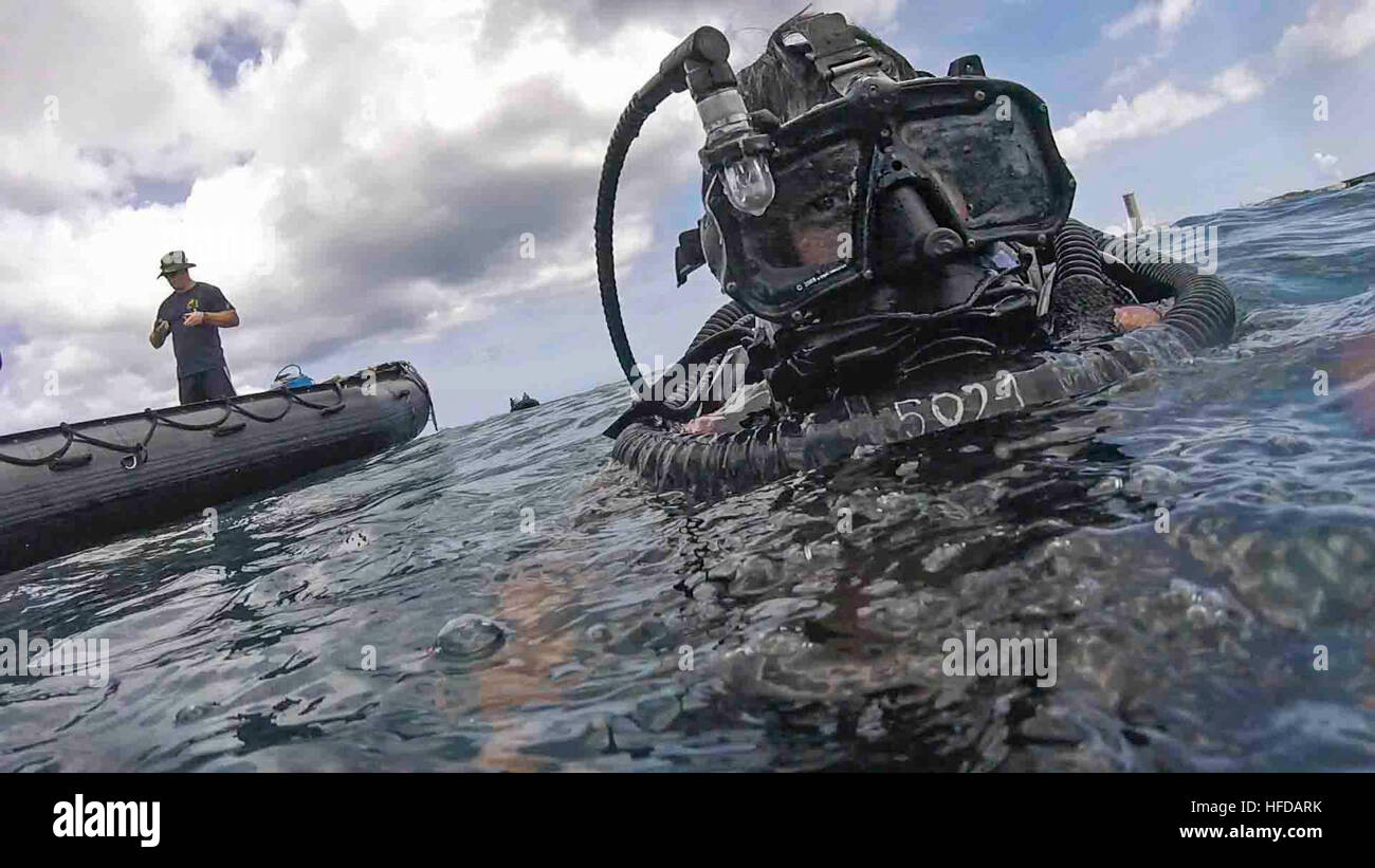 A U.S. Navy Explosive Ordnance Disposal (EOD) technician, assigned to the Explosive Ordnance Disposal Mobile Unit (EODMU) 5, participates in a Very Shallow Water (VSW) scenario during Exercise Tricrab on Naval Base Guam, May 17, 2016. Tricrab was a combined exercise involving military forces from five different countries that focuses on strengthening relationships within the Asia-Pacific region through training and information exchanges, to enhance EOD and diving related interoperability. (U.S. Navy Combat Camera photo by Mass Communication Specialist 3rd Class Alfred A. Coffield) Tricrab 2016 Stock Photo