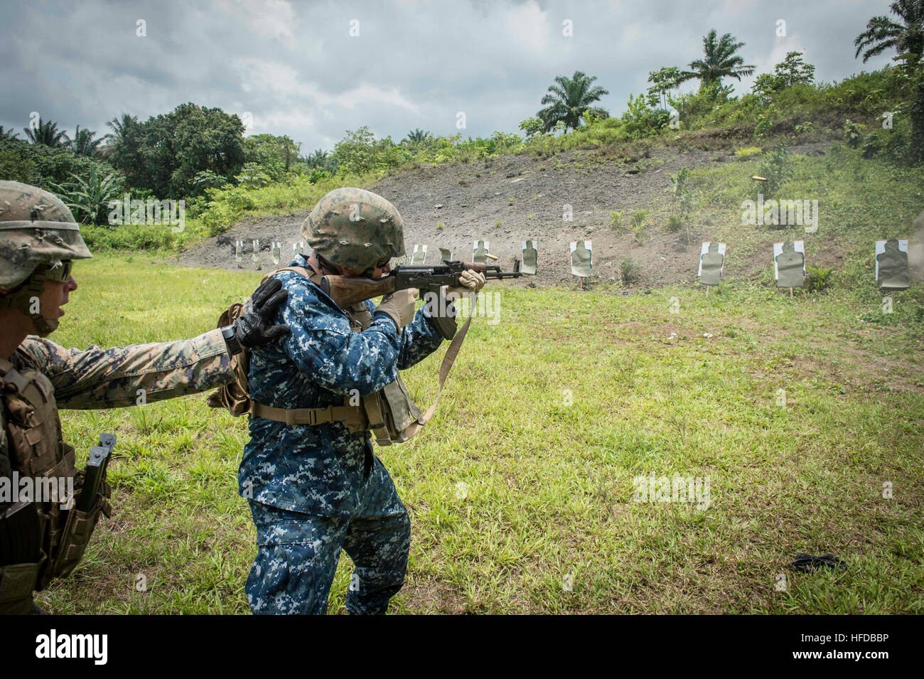 150314-N-JP249-100 ISSONGO, Cameroon (March 14, 2015) U.S. 6th Fleet Vice Commander Rear Adm. Tom Reck fires an AK-47 assault rifle March 14, 2015, on a military live-fire range in Issongo, Cameroon, during Africa Partnership Station.. Africa Partnership Station, an international collaborative capacity-building program, is being conducted in conjunction with a scheduled deployment by the Military Sealift Command’s joint high-speed vessel USNS Spearhead (JHSV 1). (U.S. Navy photo by Mass Communication Specialist 2nd Class Kenan O’Connor/Released) Africa Partnership Station 150314-N-JP249-100 Stock Photo