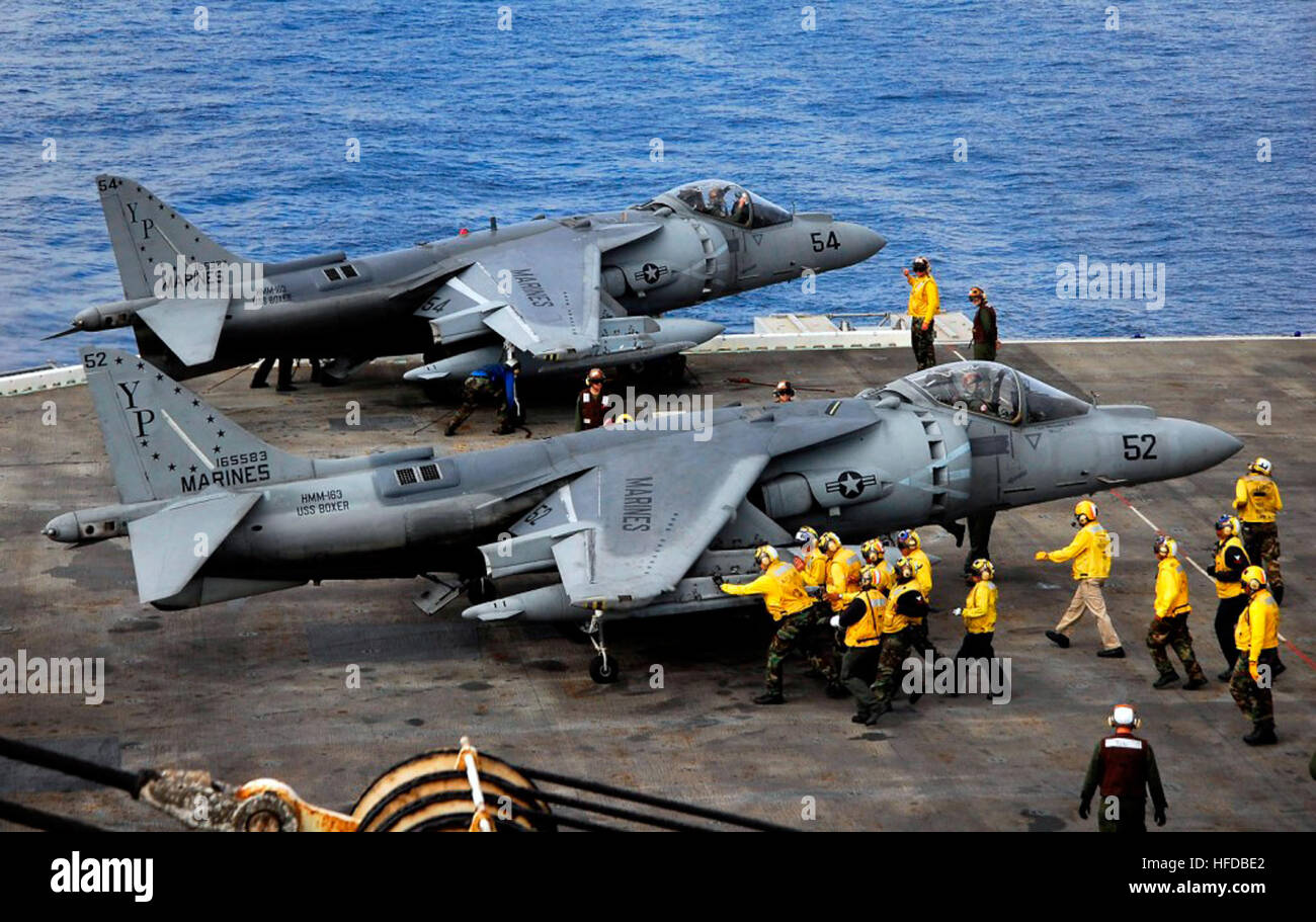 081031-N-4774B-040 PACIFIC OCEAN (Oct. 31, 2008) Flight deck crew members move an AV-8B Harrier II jet assigned to Fixed Wing Marine Attack Squadron 214 toward the aft elevator aboard the amphibious assault ship USS Boxer (LHD 4). Boxer is conducting an exercise in the Pacific Ocean preparing for a deployment scheduled for early next year. (U.S. Navy Photo by Mass Communication Specialist 3rd Class Daniel Barker/Released) Two aircraft on USS Boxer (LHD 4) Stock Photo