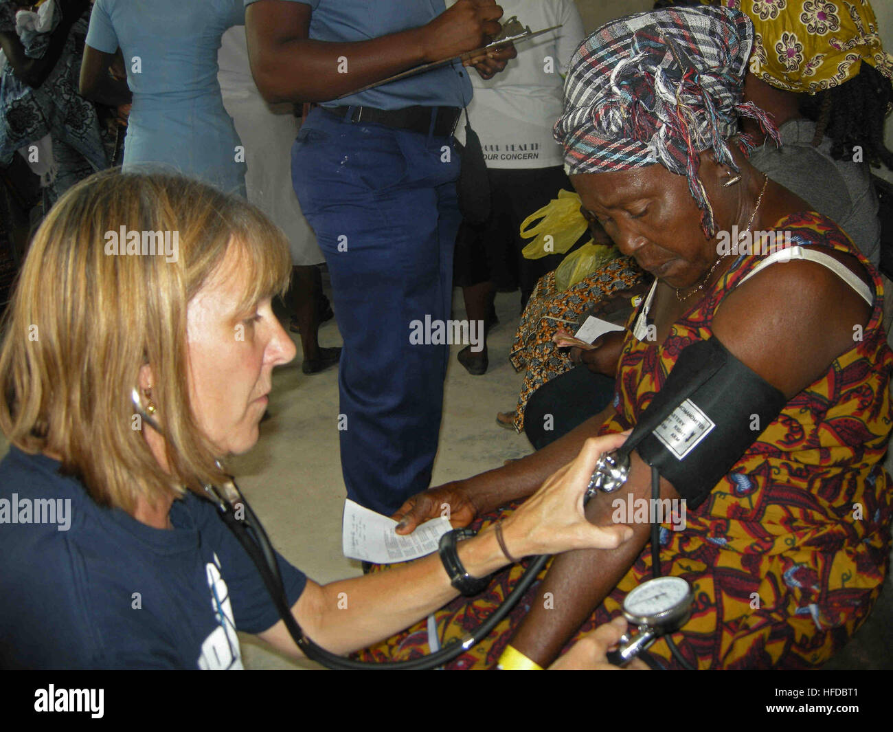 Fran Bauer, a volunteer nurse from Project Hope, checks a patient's vitals during a medical outreach health fair in support of Africa Partnership Station (APS) 2012 hosted by Ghanaian and American medical personnel from High-Speed Vessel Swift (HSV 2). APS is an international security cooperation initiative, facilitated by Commander, U.S. Naval Forces Europe-Africa, aimed at strengthening global maritime partnerships through training and collaborative activities in order to improve maritime safety and security in Africa. (U.S. Navy photo by Ensign Joe Keiley/Released). Africa Partnership Stati Stock Photo