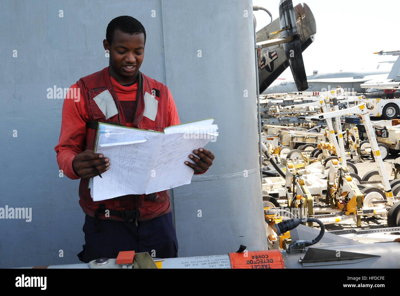 U.S. Navy Aviation Ordnanceman Airman Jeremy Brown checks an ordnance log aboard the aircraft carrier USS George H.W. Bush (CVN 77) in the Persian Gulf June 26, 2014. The George H.W. Bush supported maritime security operations and theater security cooperation efforts in the U.S. 5th Fleet area of responsibility. (U.S. Navy photo by Mass Communication Specialist 3rd Class Lorelei Vander Griend/Released) U.S. Navy Aviation Ordnanceman Airman Jeremy Brown checks an ordnance log aboard the aircraft carrier USS George H.W. Bush (CVN 77) in the Persian Gulf June 26, 2014 140626-N-MU440-024 Stock Photo